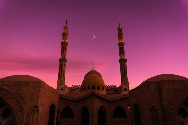 istock Beautiful large Islamic mosque at the sunset sky background 1300809482