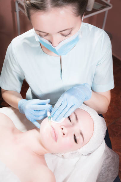 istock Cosmetic injection in a beauty parlor for a woman client 1300809877