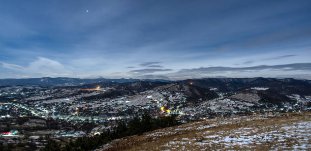 istock Night view of village in mountains during winter 1300810041
