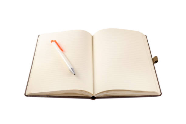 istock Office supplies - Graphite pencil on open notebook isolated on white 1300811070