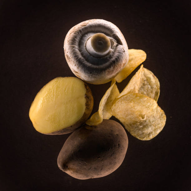 Mix of natural dirty raw ingredients and chips on brown background