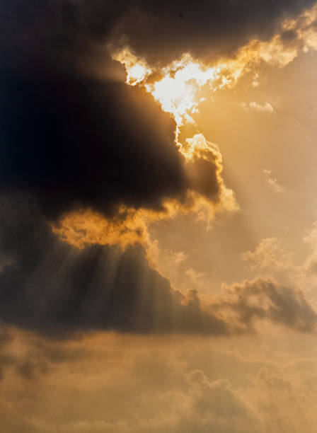 istock Yellow orange colored Sun rays came out from the clouds in the evening. 1300811215