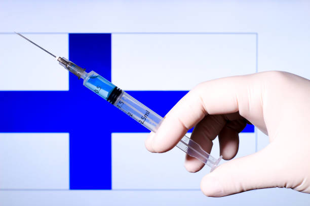istock Hand holding syringe with covid vaccine 1300814084