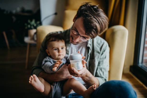 istock Father feeding his son in hight chair 1300815081