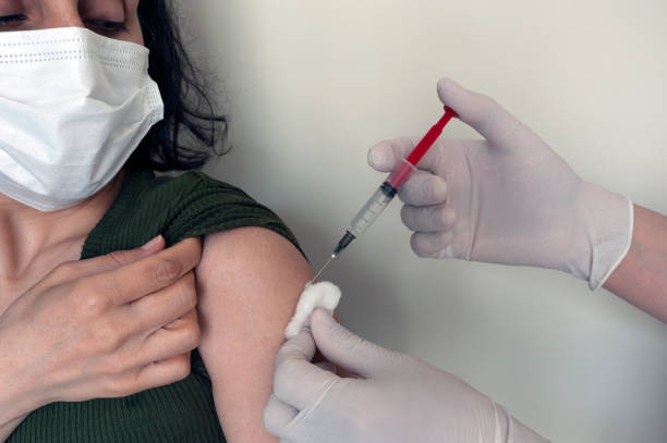 istock while getting vaccinated, vaccinating, doctor, hospital, vaccine, while the lady was getting vaccinated 1300815590