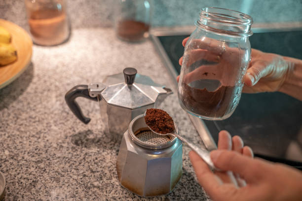 istock Woman in kitchen makes Italian coffee, she uses reusable containers 1300816517