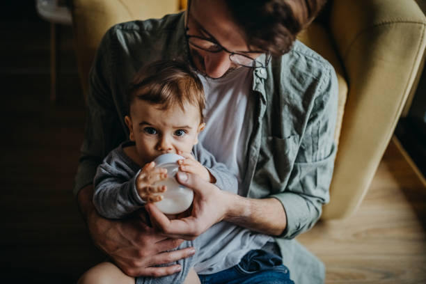 istock Father feeding his son in hight chair 1300816531