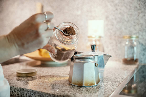 istock Woman in kitchen makes Italian coffee, she uses reusable containers 1300816655