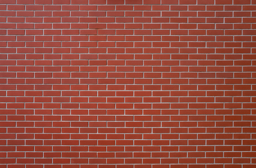 Background (top) shows exterior wall with plaster of an existing house, between the walls thermal and soundproofing material between exterior brick wall of a newly built house. Professional energy and soundproof insulation between the outer walls of terraced houses or attached buildings.