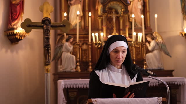 Nun reading Holly Bible in Roman Catholic church.