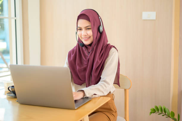 istock Muslim operator woman in headset using computer answering customer call in office, Customer service concept 1300820738