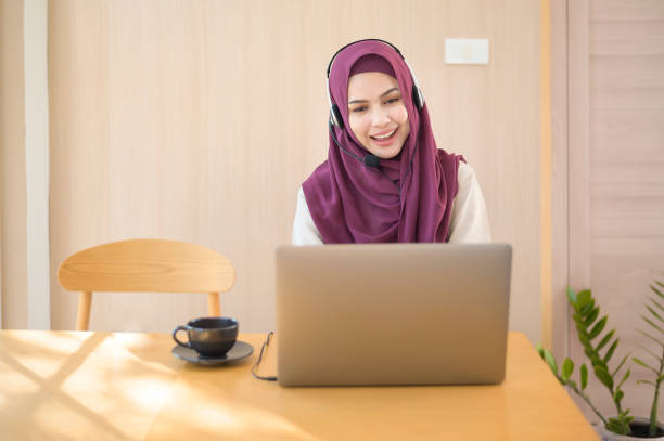 istock Muslim operator woman in headset using computer answering customer call in office, Customer service concept 1300820797
