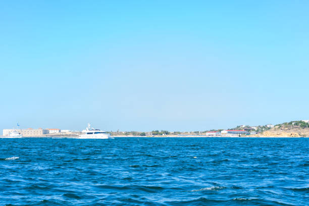 Coastline and waves in the sea, sunny Crimean summer. Horizontal orientation stock photo