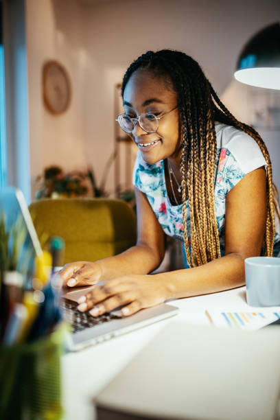 istock Vertical image of African American female student doing research on internet 1300822004