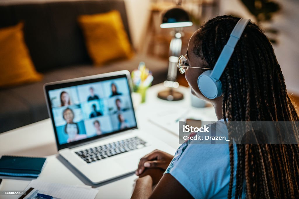 Group of unrecognisable international students having online meeting African American female student studying from home during lockdown Internet Stock Photo
