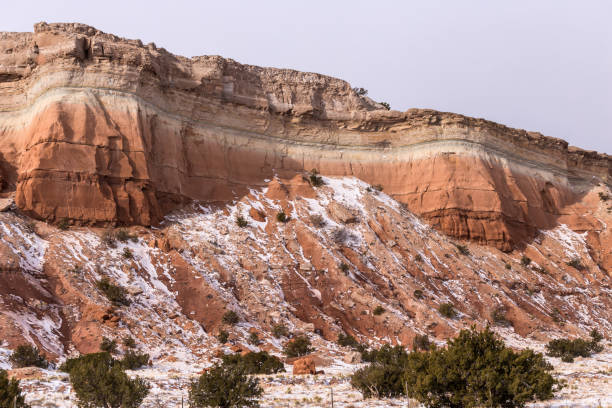 istock Differing color formations on mountainside with snow on clear day in rural New Mexico 1300823668