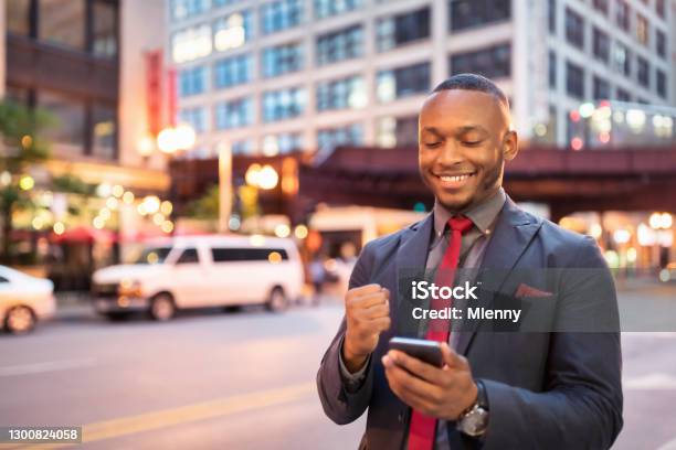 Businessman Reading Good News On Mobile Phone In Downtown Chicago Stock Photo - Download Image Now