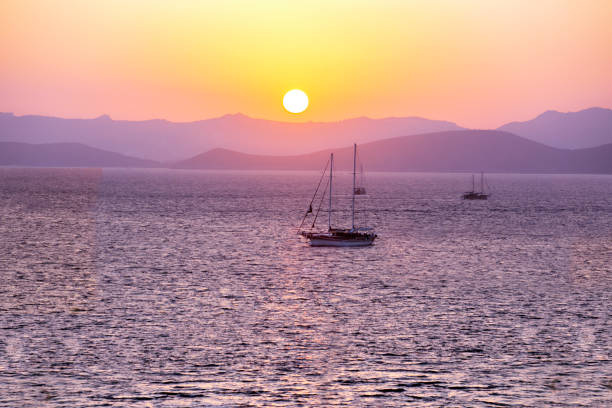istock Sailboats at sunset. Beautiful sea sunset background. 1300825314
