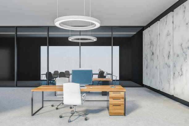 istock Grey office room with chairs and computer on wooden tables, marble floor 1300825428