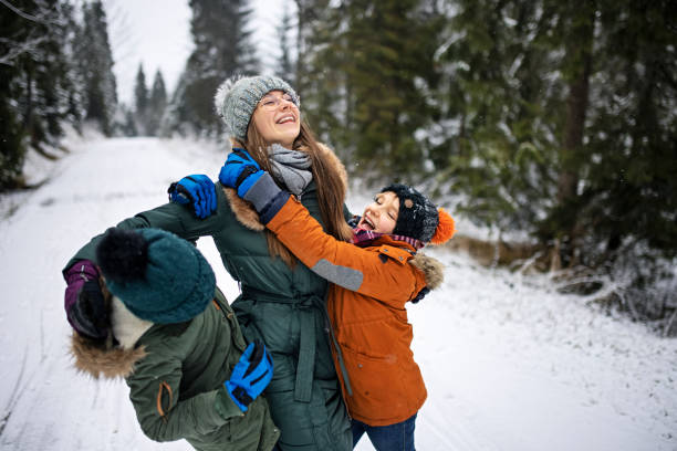 istock Kids enjoying hiking in winter forest. 1300827130