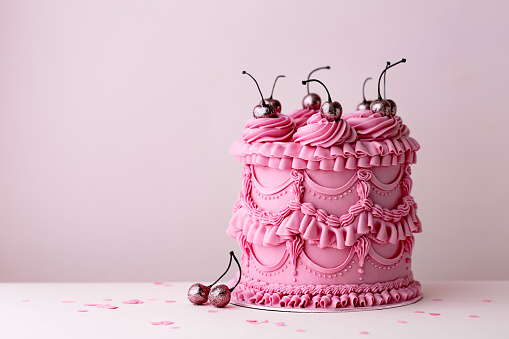 Ornate birthday cake with vintage style buttercream ruffles and cherries