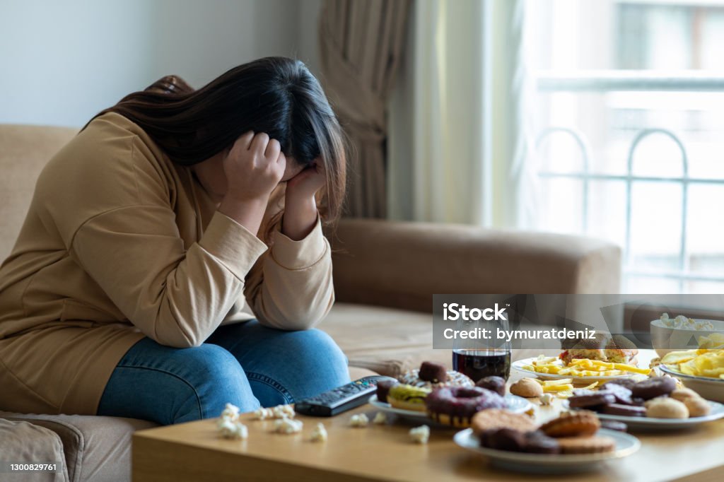 Unhappy stressed woman Eating Stock Photo