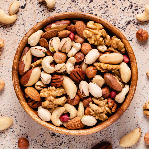 istock Various Nuts in wooden bowls 1300830978