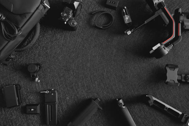 istock top view of work space photographer with digital camera, Gimbal Stabilizers and camera accessory 1300831035
