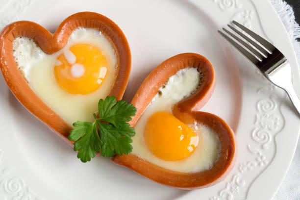 istock sausage with scrambled egg in the shape of a heart. 1300832012