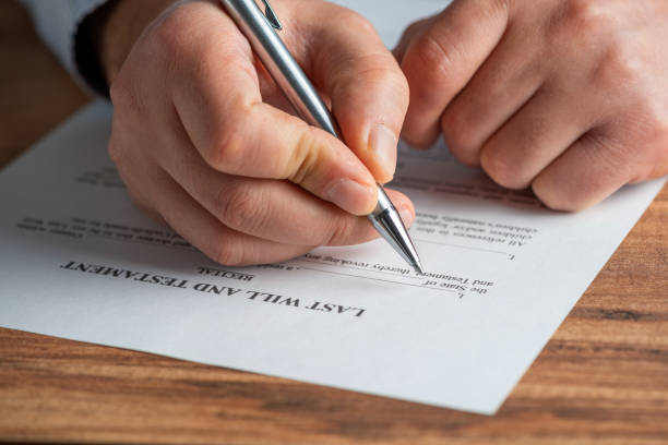 istock A hand with a pen filling out an Last Will and Testament 1300834063