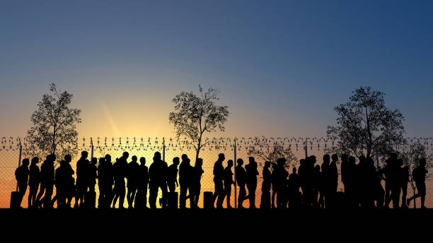 Column of migrants near the state borders. Fence and barbed wire. Surveillance, supervised. Refugees and immigrants Refugees and immigrants looking for a new life. Column of migrants near the state borders. Fence and barbed wire. Surveillance, supervised. Abandon their lands for a better future. 3d render. Silhouette emigration and immigration stock pictures, royalty-free photos & images