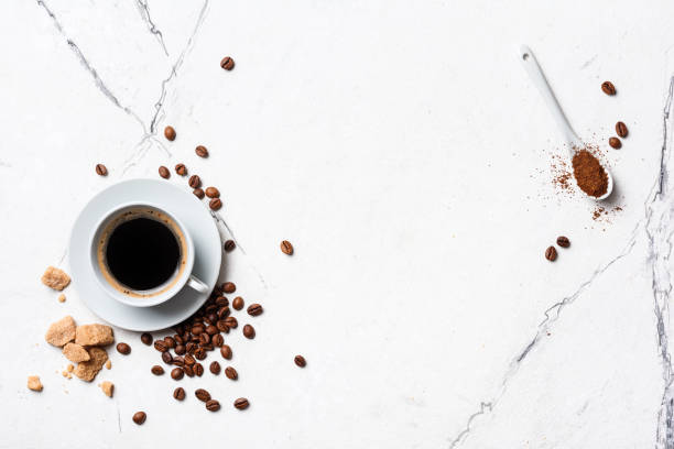 istock Black coffee in white cup with cane lump sugar 1300834319