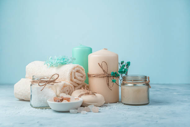 istock Spa set with candles on a light blue background. Side view with copy space 1300834516