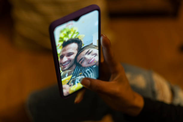 istock Couple enjoy watching their Christmas tree 1300834530