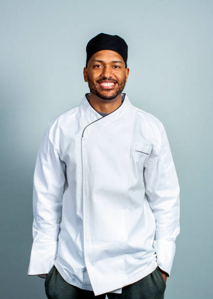 istock Happy male cook on gray background 1300835456
