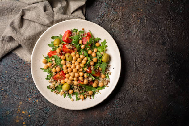istock Salad with cooked chickpeas, fresh arugula, chia seeds and cherry tomatoes 1300836545