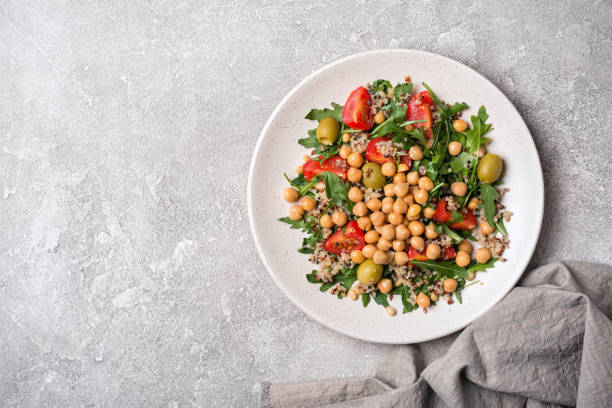 istock Salad with cooked chickpeas, fresh arugula, chia seeds and cherry tomatoes 1300836548