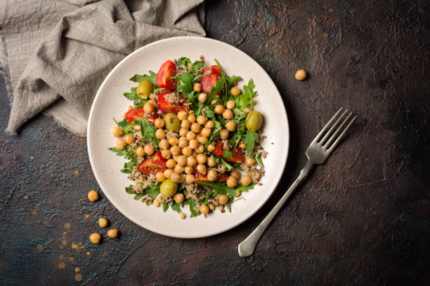 istock Salad with cooked chickpeas, fresh arugula, chia seeds and cherry tomatoes 1300836621