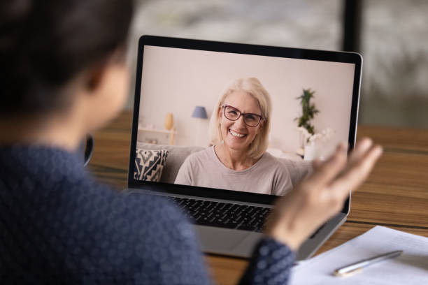 istock Back view of woman talk on webcam with teacher 1300836707