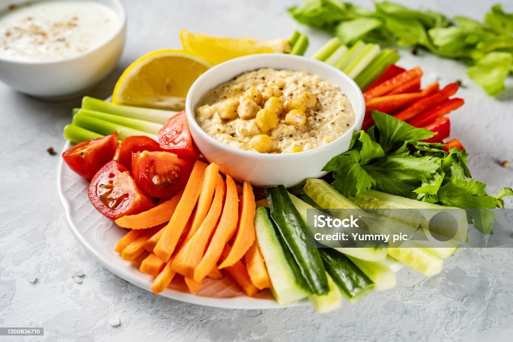 Crop shot of plate with colorful healthy sliced vegetables and dips A plate with colorful healthy sliced vegetables and dips. Close up. Healthy vegetarian food Vegetable Stock Photo