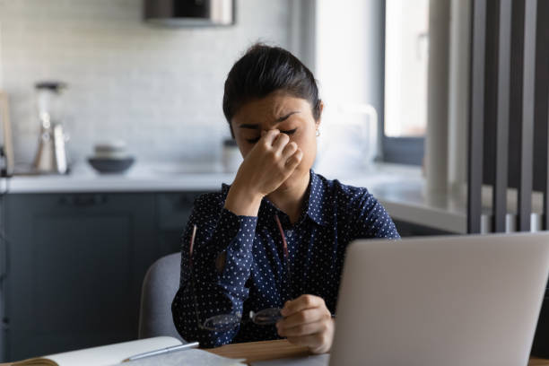 istock Tired Indian woman suffer from headache working on computer 1300836751