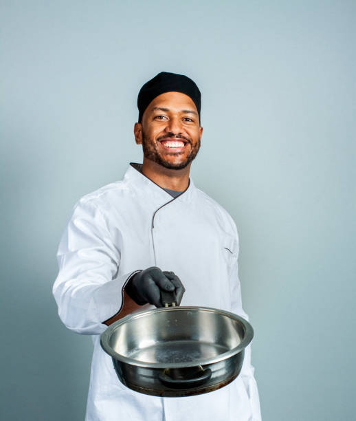 Happy male chef with saucepan