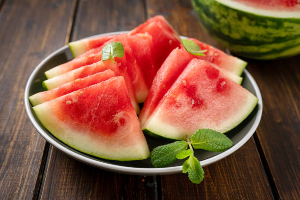 istock Seedless watermelon slices in a plate on the wooden table 1300836890