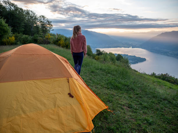 istock Woman camping on mountain top, sunrise 1300838186