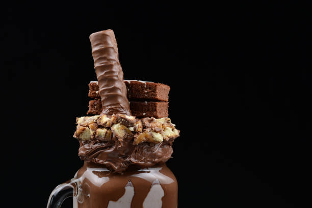 istock Chocolate extreme milkshake with brownie cake, chocolate paste and sweets. Crazy freakshake food trend. Copy space 1300839473