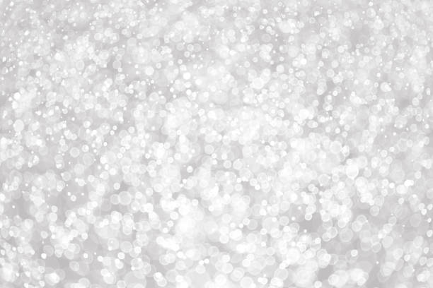 istock Silver and white bokeh lights defocused. abstract background 1300839914
