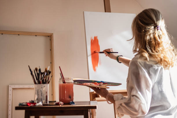 istock Female art painter painting on canvas at her studio 1300842880