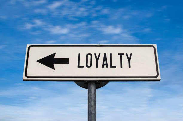 Loyalty road sign, arrow on blue sky background. One way blank road sign with copy space. Arrow on a pole pointing in one direction. Loyalty road sign, arrow on blue sky background. One way blank road sign with copy space. Arrow on a pole pointing in one direction. loyalty stock pictures, royalty-free photos & images