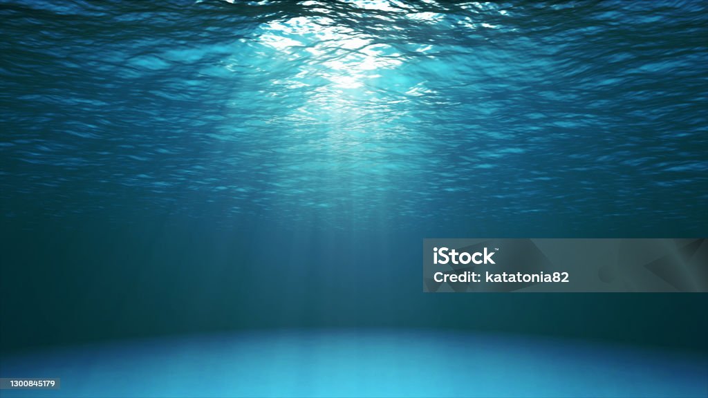 Dark blue ocean surface seen from underwater Dark blue ocean surface seen from underwater. Abstract waves underwater and rays of sunlight shining through Sea Stock Photo