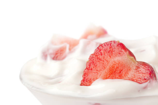 istock delicious fresh strawberry falling into glass with yogurt 1300845884